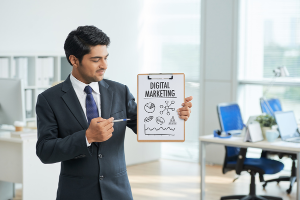 7 Man in suit standing in office with clipboard and pointing to poster with words
